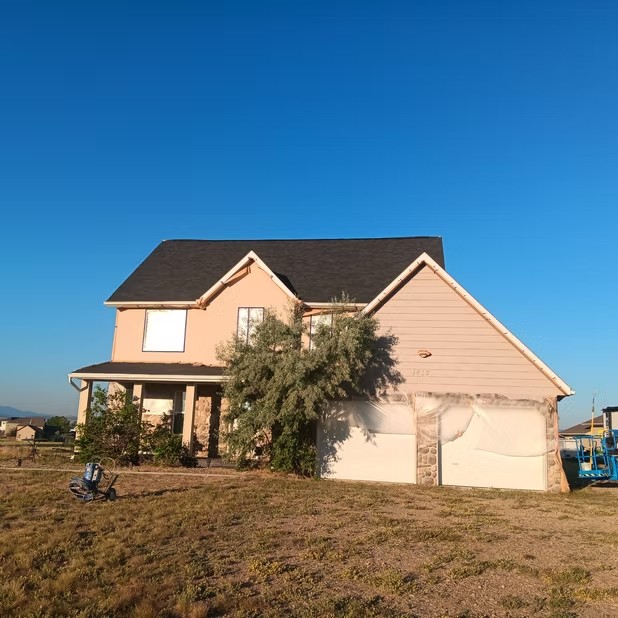 Two-story tan home and garage
