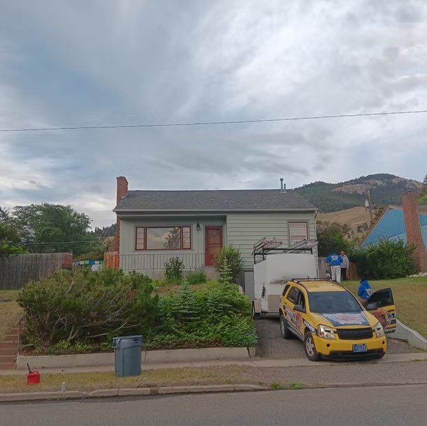 House exterior with work vehicle